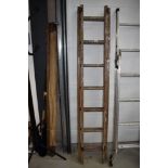 A set of vintage wooden extending ladders
