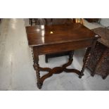 An early 20th Century oak side table having twist legs and 'X' frame, width approx. 76cm