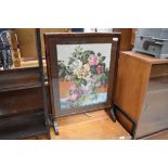 An early 20th Century stained frame embroidered fire screen