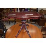 A reproduction Italian style coffee table on carved triple splay pedestal, width approx. 98cm