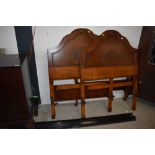A pair of mid 20th Century mahogany and walnut single bed frames