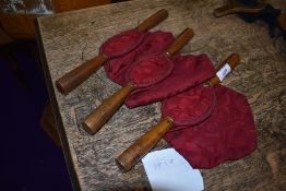 A selection of collection or offering bags having oak handles.