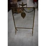 A traditional brass mirrored fire screen having urn and swag decoration, width approx. 45cm