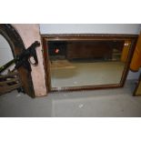 A reproduction mahogany effect gilt mirror, approx. 86 x 59cm