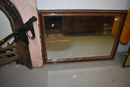 A reproduction mahogany effect gilt mirror, approx. 86 x 59cm
