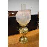 A Victorian style brass oil lamp, with glass chimney and opaque shade