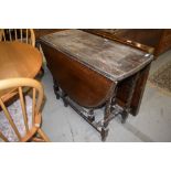 An early to mid 20th Century oak part stripped twist gate leg table