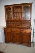 A modern pine dresser having glazed upper section, width approx 132cm, height 190cm