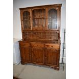 A modern pine dresser having glazed upper section, width approx 132cm, height 190cm