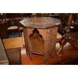 An octagonal carved occasional table, in the Celtic style, width approx. 45cm, height 47cm