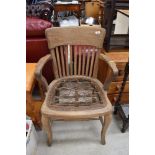 A traditional stripped oak armchair with strung base, upholstery project