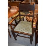 An early to mid 20th Century traditional oak carver chair having rail back and later upholstery