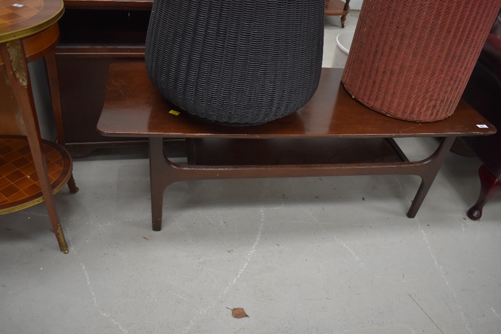 A vintage mahogany coffee table, of stylised form, approx. 117 x 39cm