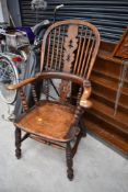 A 19th Century oak Windsor style armchair, with splat, spindle and turned back on reinforced H