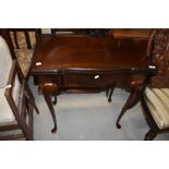 An early 20th Century mahogany fold over card table, having shaped edge on cabriole legsm width