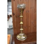 A large brass candlestick of ecclesiastical form, height approx. 52cm