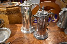 Two communion service or similar silver plated lidded jugs