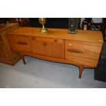 A gorgeous vintage teak sideboard having contrasted stylised handles and shaped legs, width