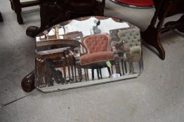 A vintage frameless wall mirror