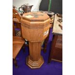 An early 20th century oak baptism font having copper liner,carved with ' He took them up in his arms