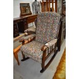 A dark stained Ercol style upholstered rocking chair