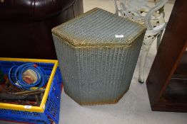 A vintage Lloyd Loom corner linen basket