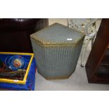 A vintage Lloyd Loom corner linen basket