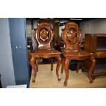A pair of 19th Century mahogany shield back hall chairs