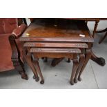 A nest of three mid 20th Century walnut tables