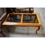 A modern yew effect and smoked glass top coffee table, approx. 96 x 49cm