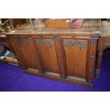 A church vestibule tabernacle base having extensive gothic decoration in traditional oak with