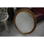 A vintage gilt oval wall mirror, approx. 70 x 55cm