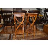A pair of hardwood plant stands, having stylised frames, each approx. height 75cm
