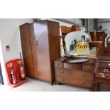 A mid 20th Century oak and ply wardrobe and dressing table