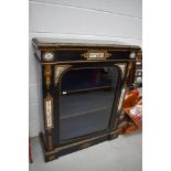 A 19th Century Empire style ebonised glazed pier cabinet having gilt metal and enamel decoration,