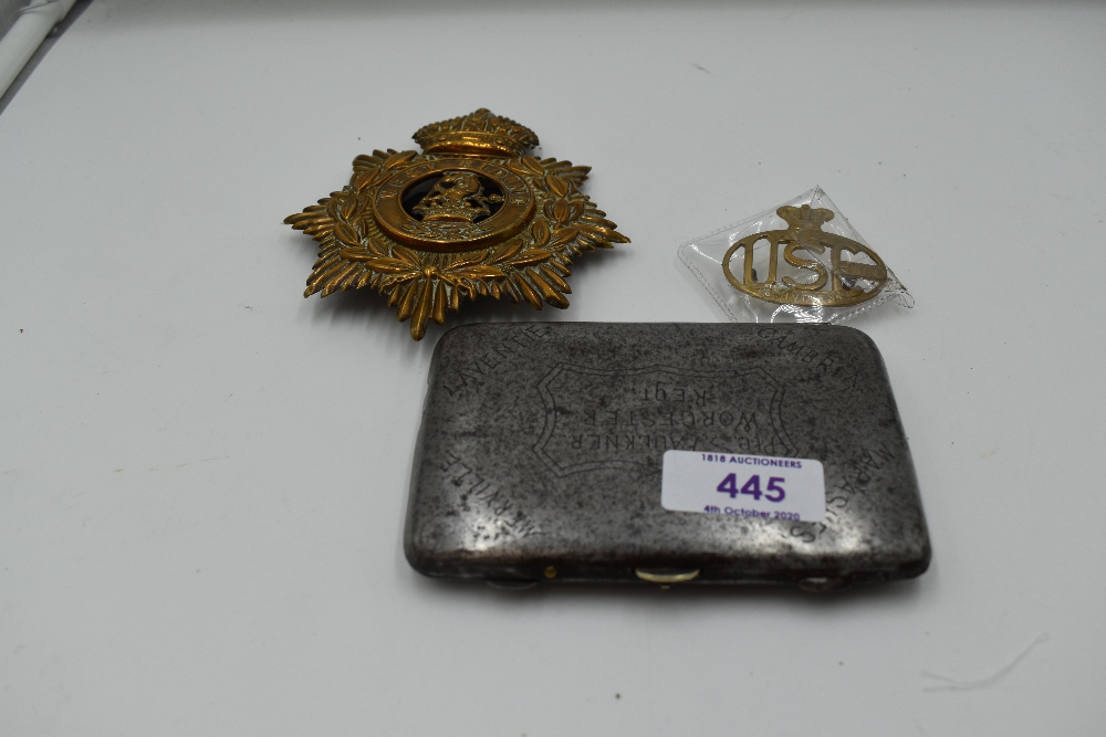 A West Riding Brass Helmet plate with clasp, a United Services Corps brass Cap Badge and a white