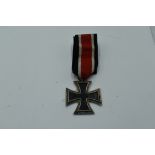 A WW2 German Iron cross with Swastika and 1939 on face, 1813 on reverse, with ribbon