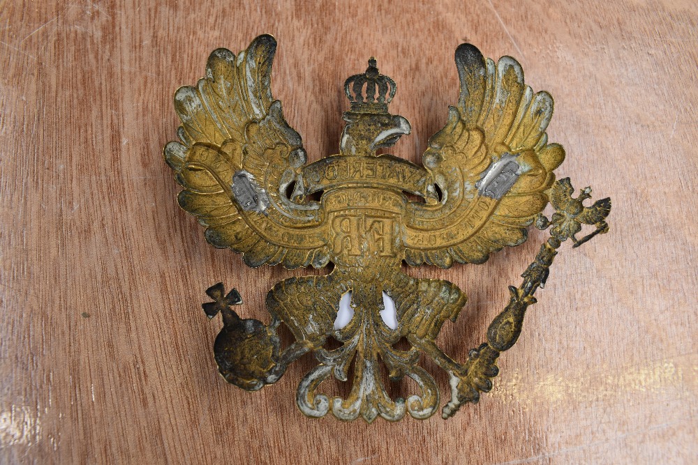 A German Prussian helmet plate in the form of an eagle bearing staff and orb with inscription - Image 2 of 2