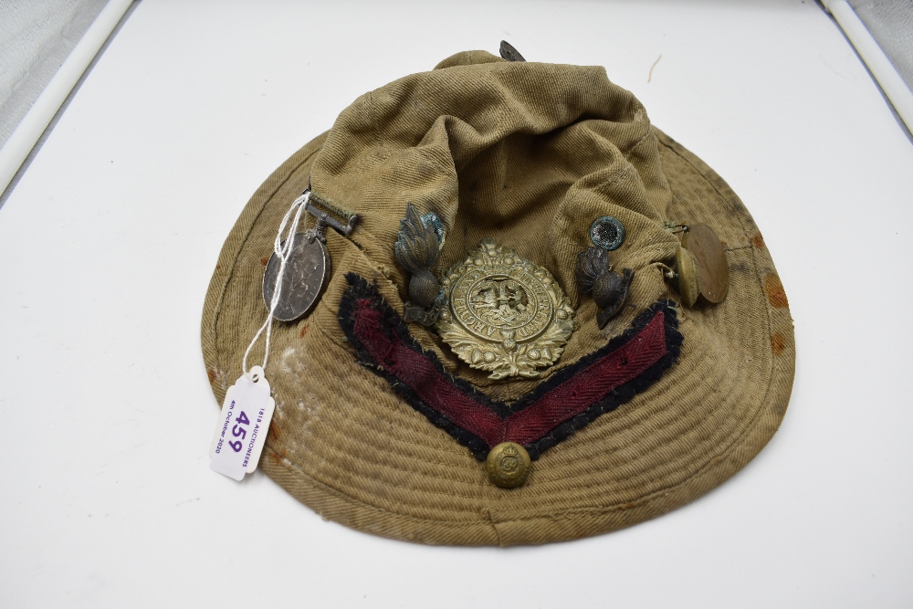 A vintage Jungle Hat having many Cap Badges and a WW1 Great war Medal for 1316 T.S. T.F.Kisby. TR.