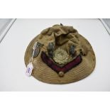 A vintage Jungle Hat having many Cap Badges and a WW1 Great war Medal for 1316 T.S. T.F.Kisby. TR.