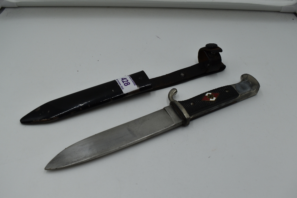 A German Third Reich Hitler Youth Dagger having black chequered grip with enamelled swastika emblem,