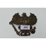 A German Prussian helmet plate in the form of an eagle bearing staff and orb with inscription