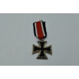 A German WW2 Second Class Iron Cross, Swastika and 1939 on face, 1813 on reverse, with ribbon,