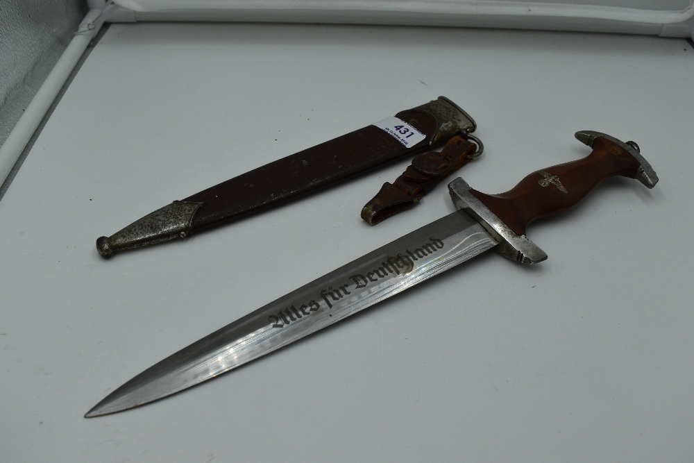 A German SA Service Dagger c1933 with metal scabbard, grip with National Socialist Emblem and SA