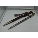 A German Third Reich Police Dagger, brown leather and metal scabbard, silver portepee knot, single