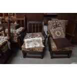 A pair of reclined low arm chairs in a farm house design by Ercol