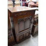 A priory styled oak cupboard having internal compartments