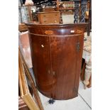 A 19th Century mahogany and inlaid bow fronted corner cupboard