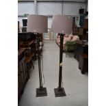 A pair of modern bronze effect standard lamps