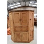 A Victorian stripped pine pantry cupboard, having panelled doors and drop flap centre section,